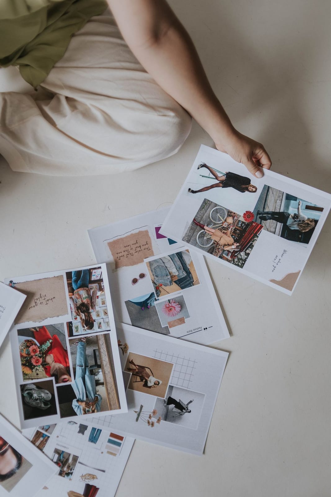 Printed fashion mood boards arranged on the floor