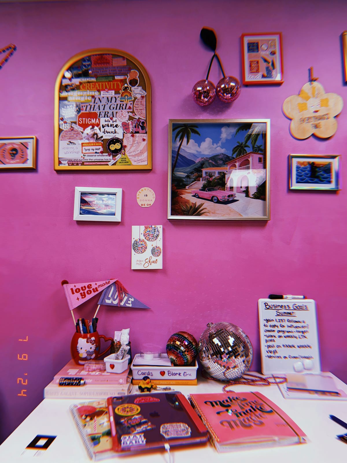 A colourful, maximalist mood board wall with disco balls